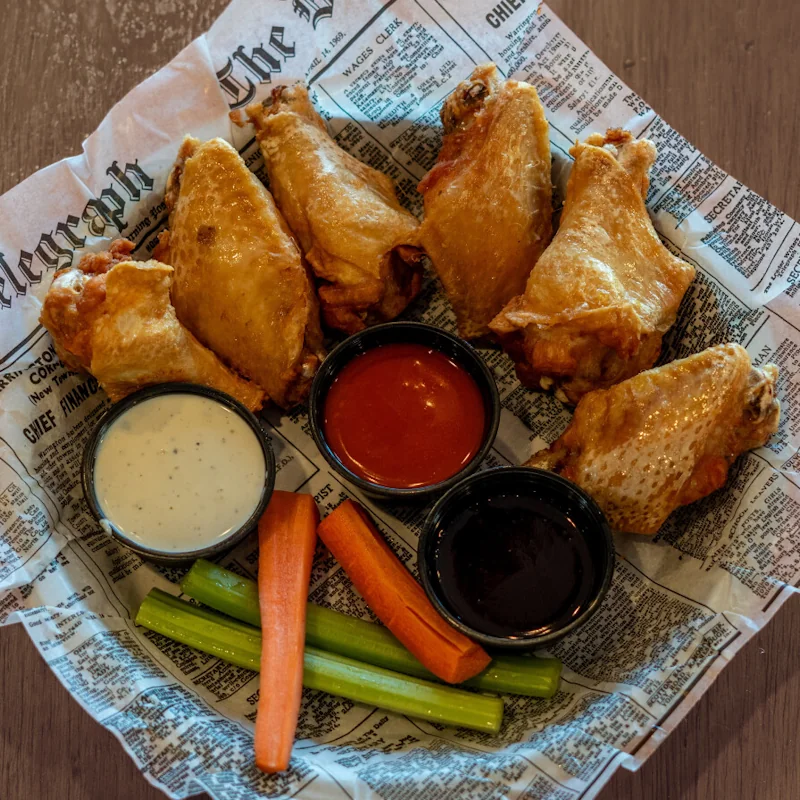 Bone-in chicken wings with celery and carrot sticks